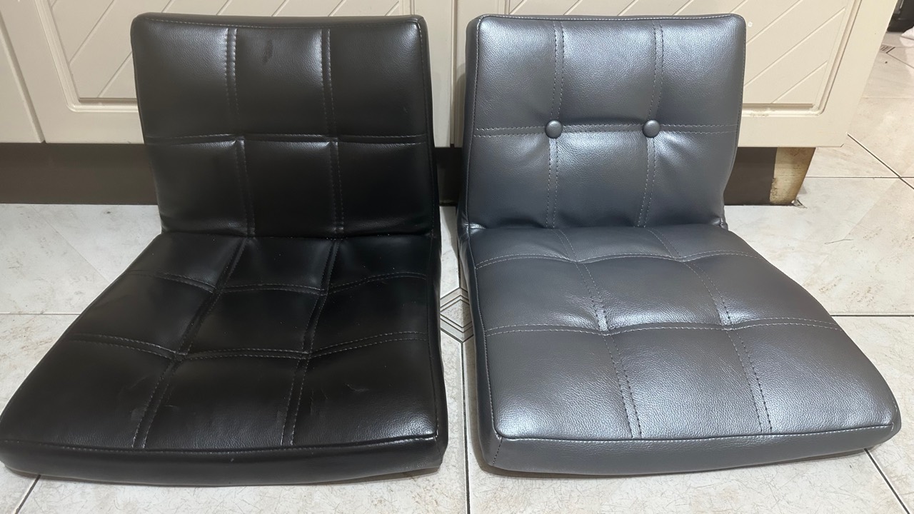 Black and grey upholstered dining chairs shown side by side